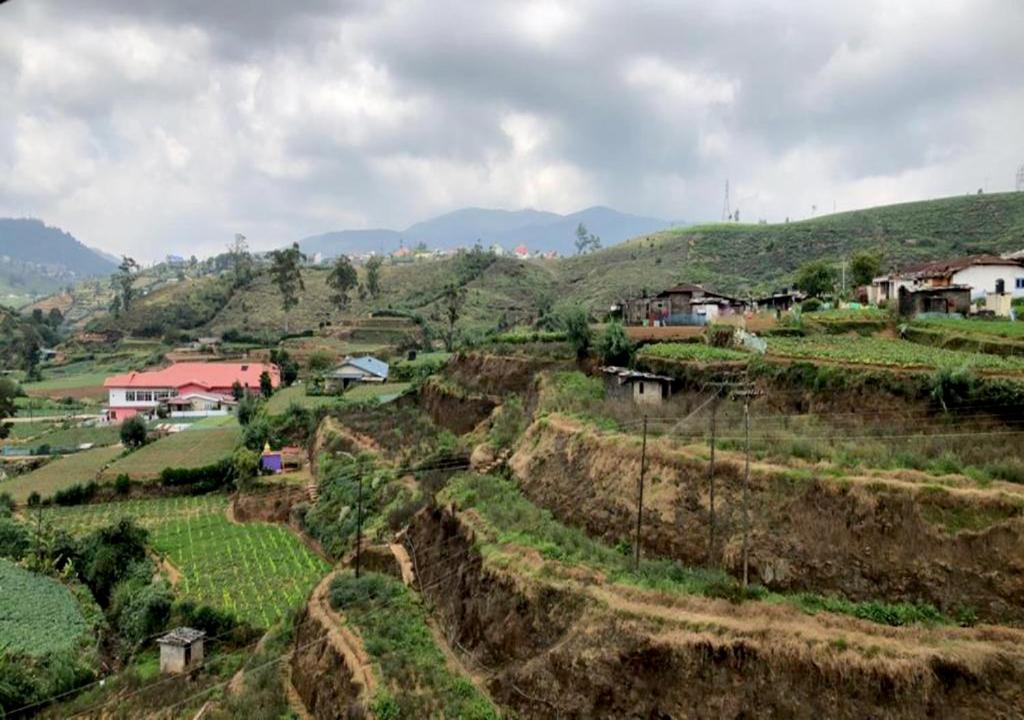 a village on a hillside with houses on it at The Blackpool Resort & Spa in Nuwara Eliya