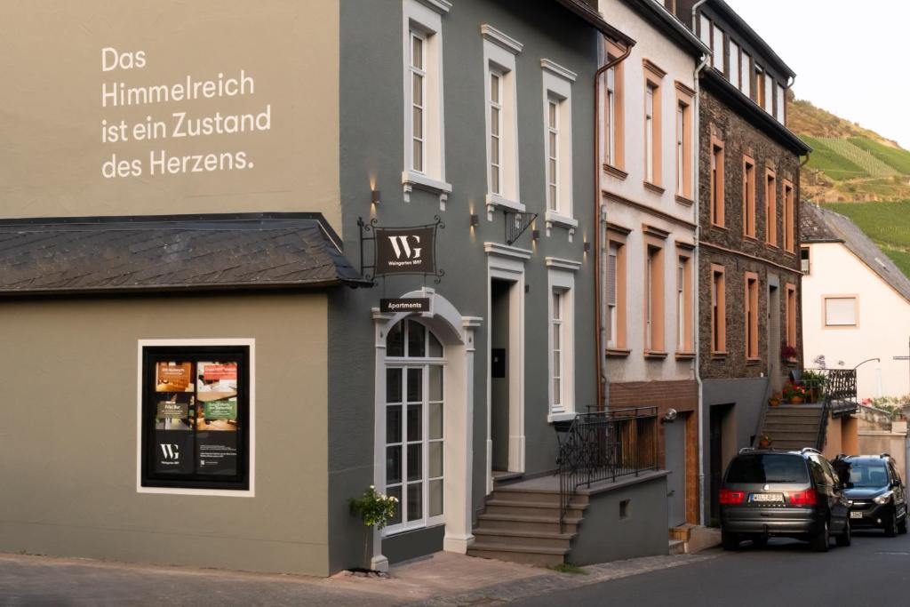 a building with a sign on the side of a street at Weingarten 1897 in Zeltingen-Rachtig