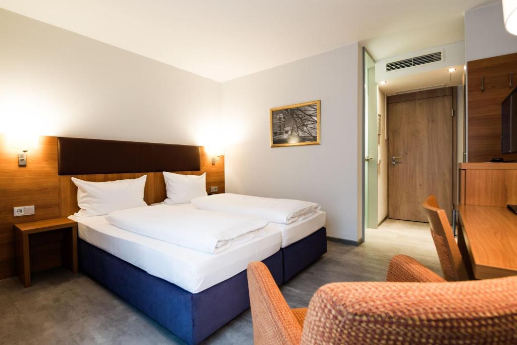 Postel nebo postele na pokoji v ubytování domus Hotel