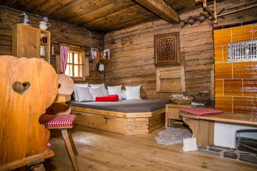 a bedroom with a bed in a wooden cabin at Tradlhof in Thierbach
