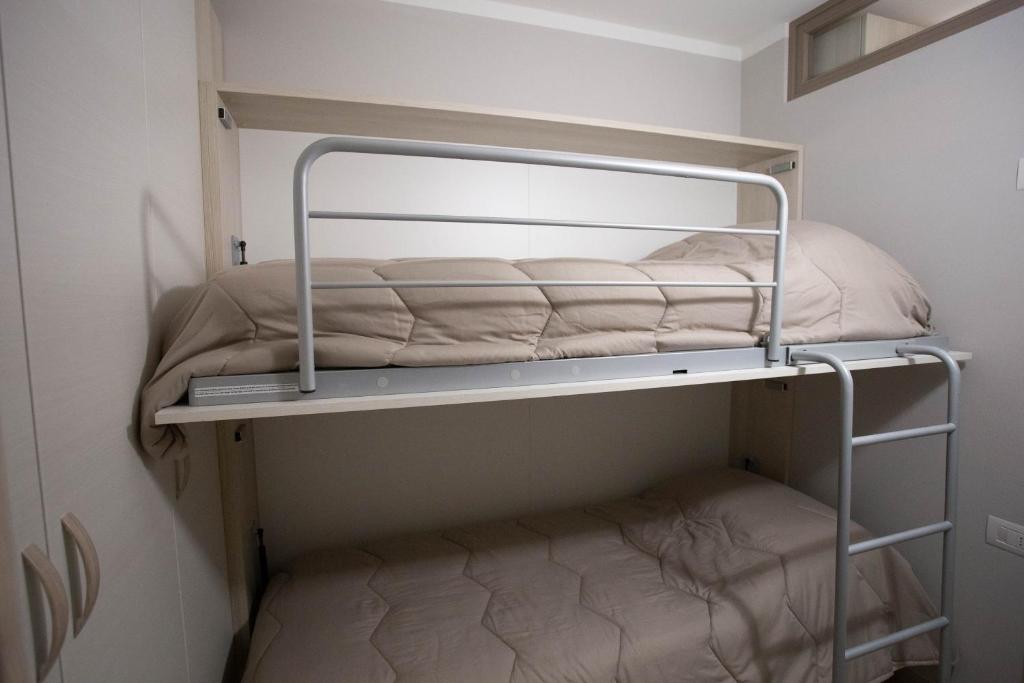 Postel nebo postele na pokoji v ubytování Perla delle Dolomiti