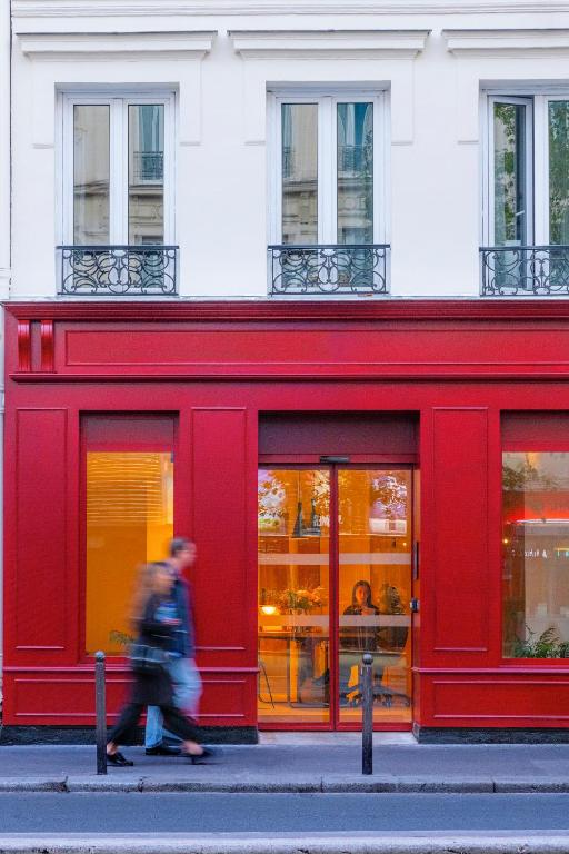 a red store front with people walking in front of it at 9Hotel Bastille-Lyon in Paris