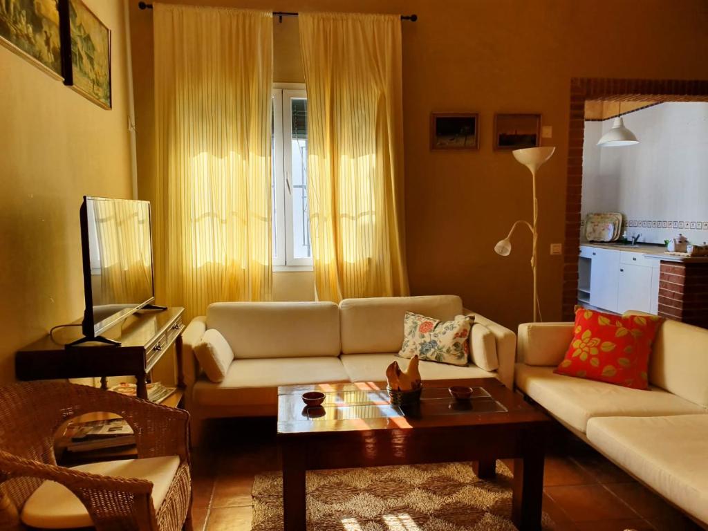 a living room with a couch and a coffee table at Vive la campiña Sevillana - Terraza y 3 Hab in El Viso del Alcor