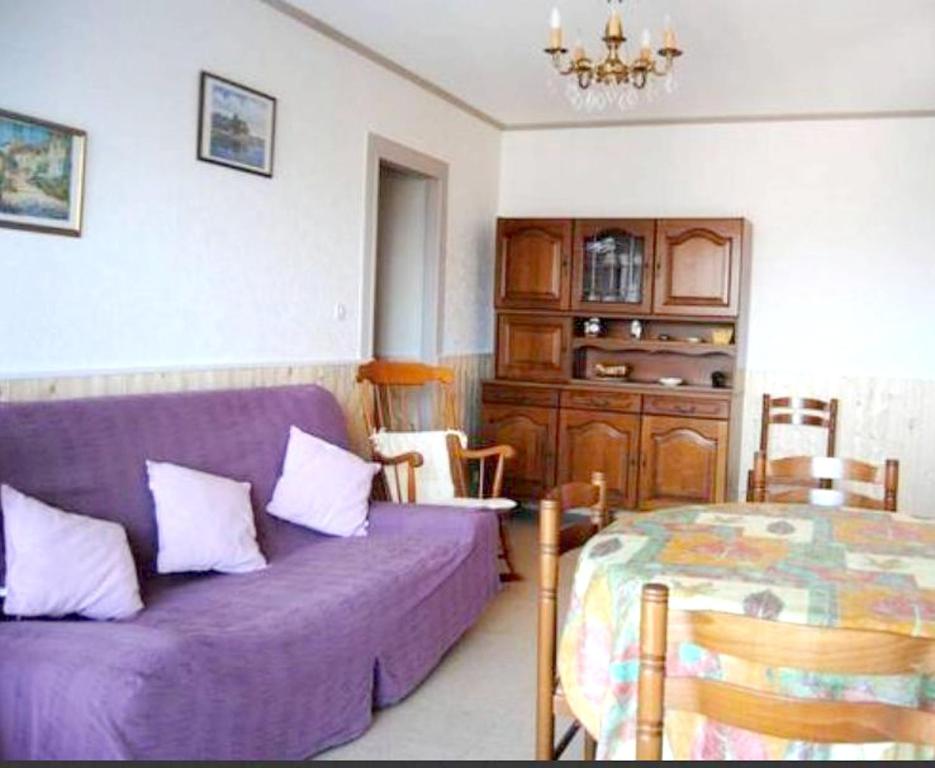 a living room with a purple couch and a table at Appartement de 2 chambres a Villers sur Mer a 150 m de la plage in Villers-sur-Mer