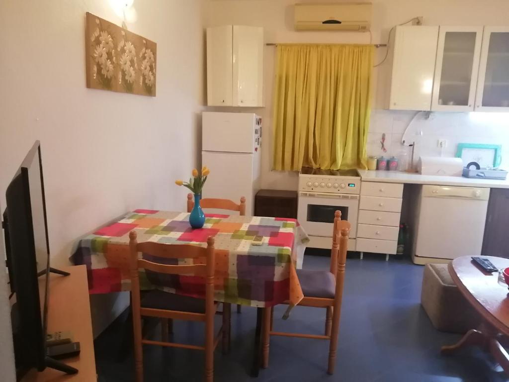 a kitchen with a table and chairs in a kitchen at Apartment with one bedroom in Kotor