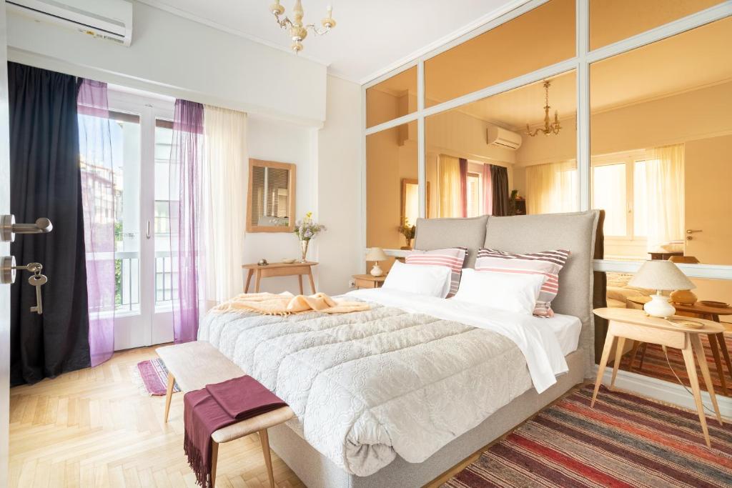 a bedroom with a large bed and a large window at A Short Walk to Syntagma and Plaka by Athenian Homes in Athens