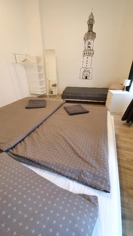 Posteľ alebo postele v izbe v ubytovaní Előkapu Apartman