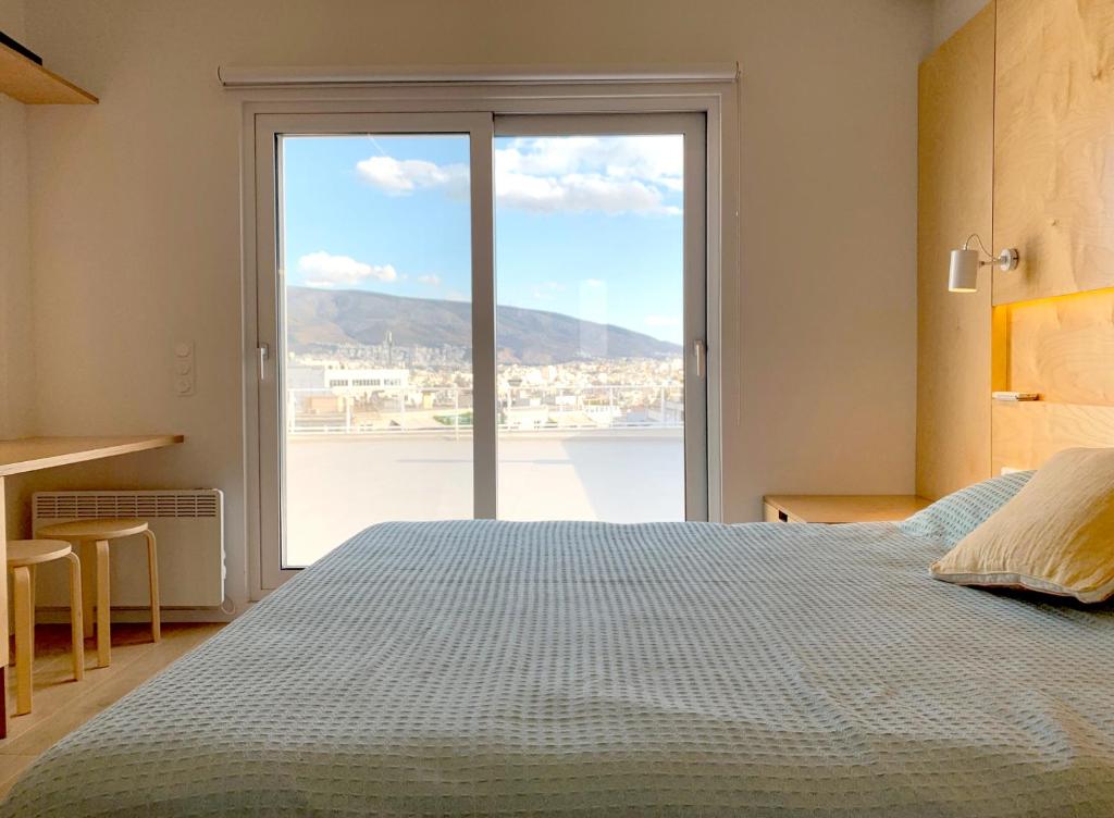 a bedroom with a bed and a large window at Kolonaki Terrace in Athens