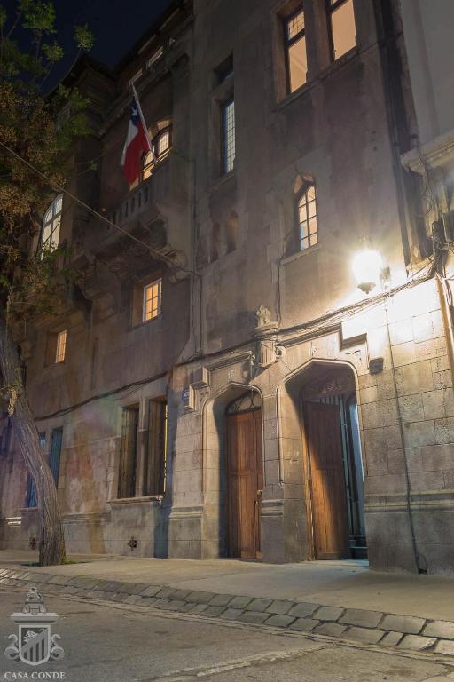a building with a flag on the side of it at Hotel Boutique Casa Conde in Santiago