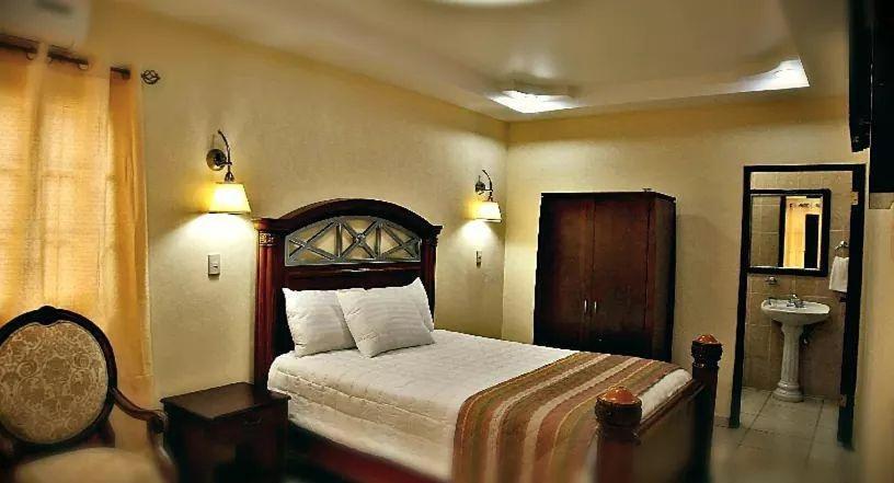 Postel nebo postele na pokoji v ubytování Hotel Carnaval