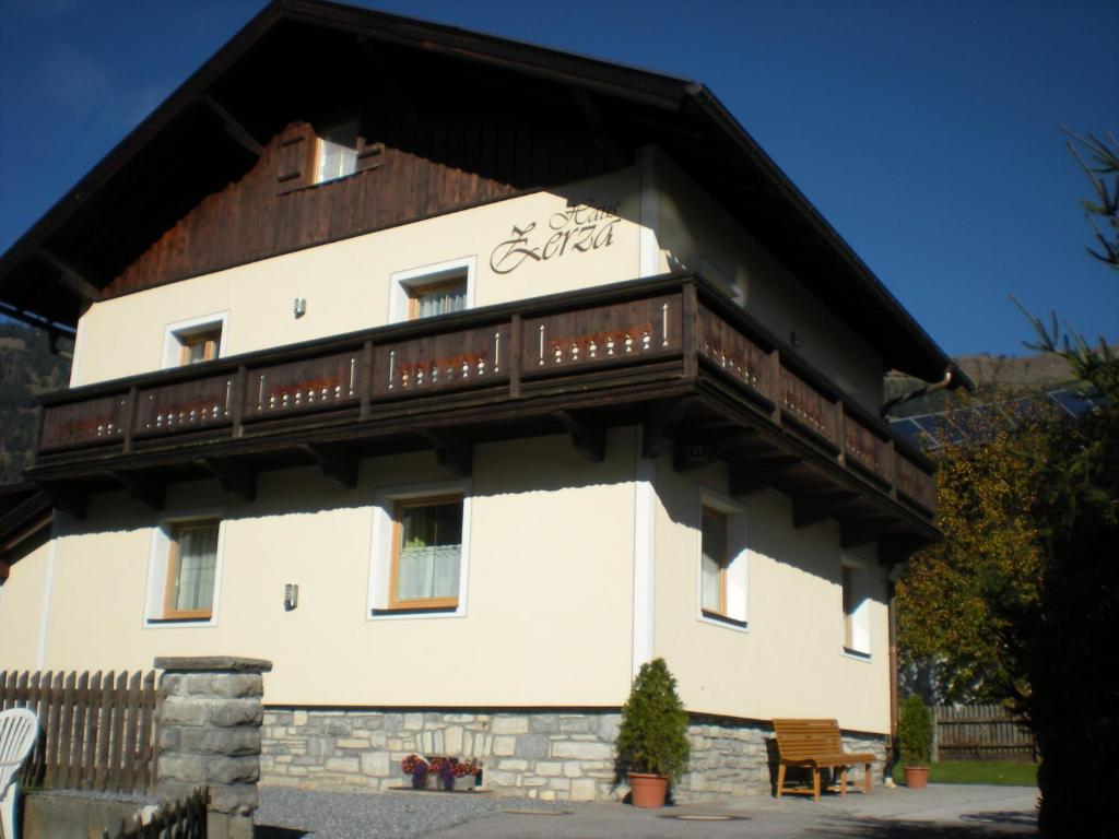 a large white building with a wooden roof at Haus Zerza in Dorfgastein