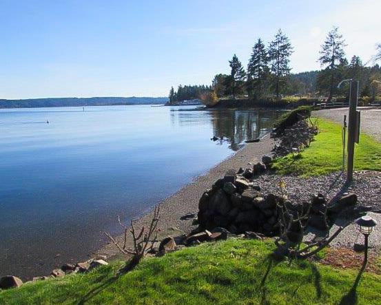 a large body of water with a rocky shore at The Waterfront at Potlatch in Shelton