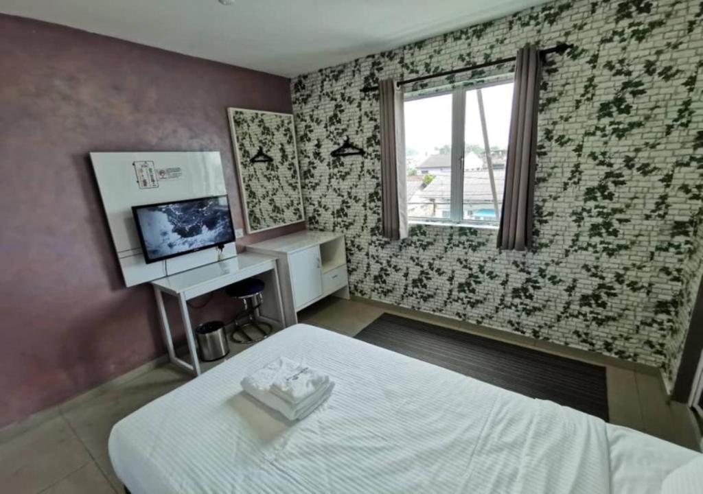 Postel nebo postele na pokoji v ubytování Yew Boutique Hotel