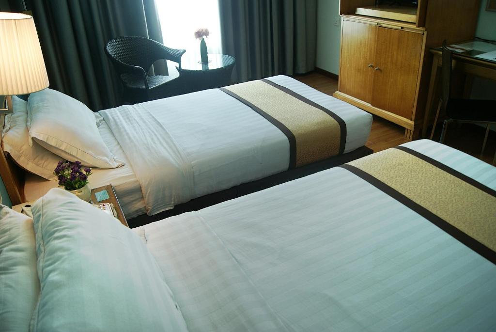 Postel nebo postele na pokoji v ubytování Tang Dynasty Bay Hotel