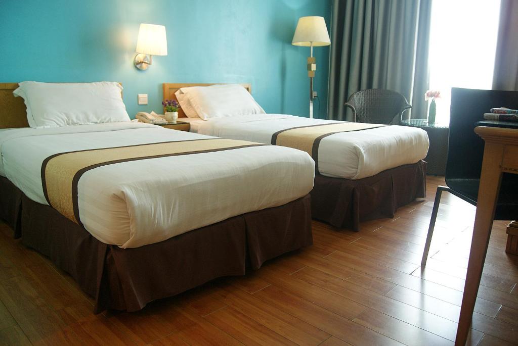 Postel nebo postele na pokoji v ubytování Tang Dynasty Bay Hotel