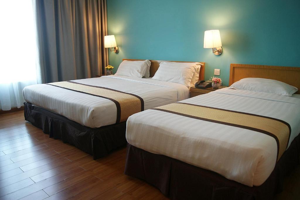 Postel nebo postele na pokoji v ubytování Tang Dynasty Bay Hotel