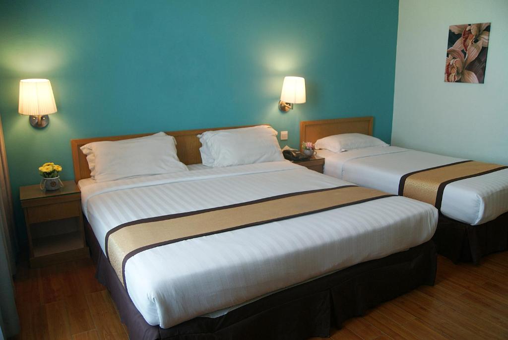 Postel nebo postele na pokoji v ubytování Tang Dynasty Bay Hotel