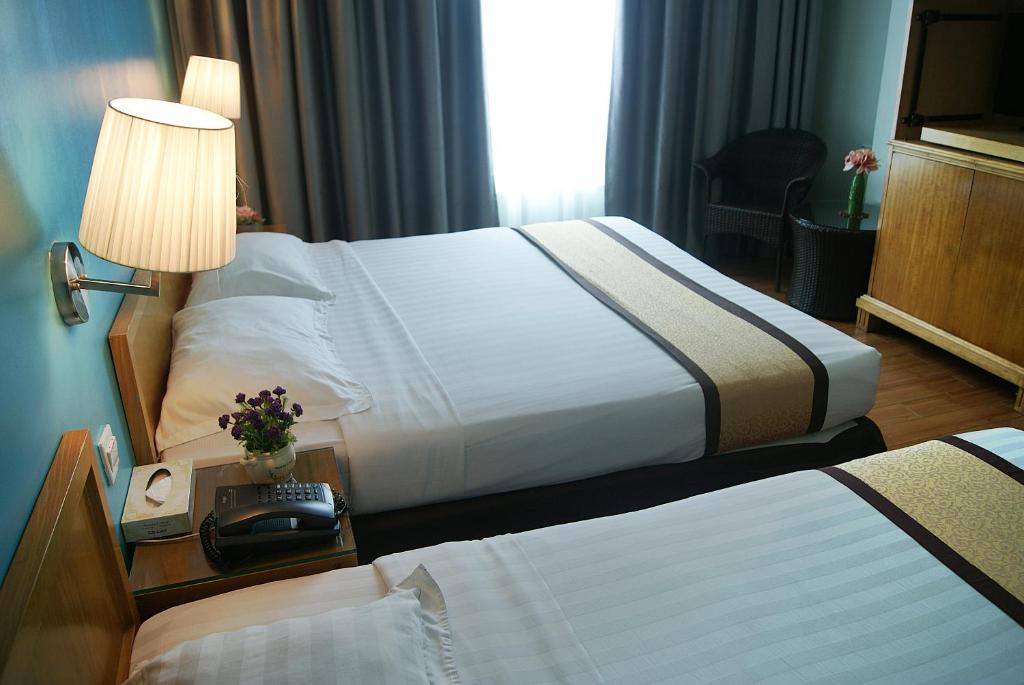 Postel nebo postele na pokoji v ubytování Tang Dynasty Bay Hotel