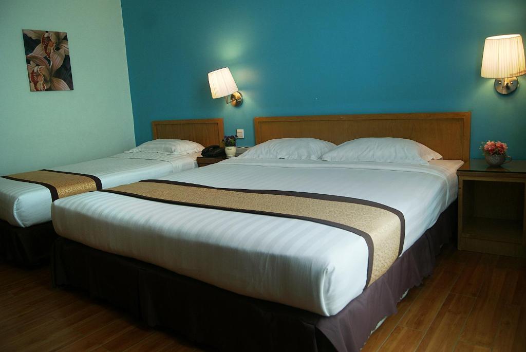 Postel nebo postele na pokoji v ubytování Tang Dynasty Bay Hotel