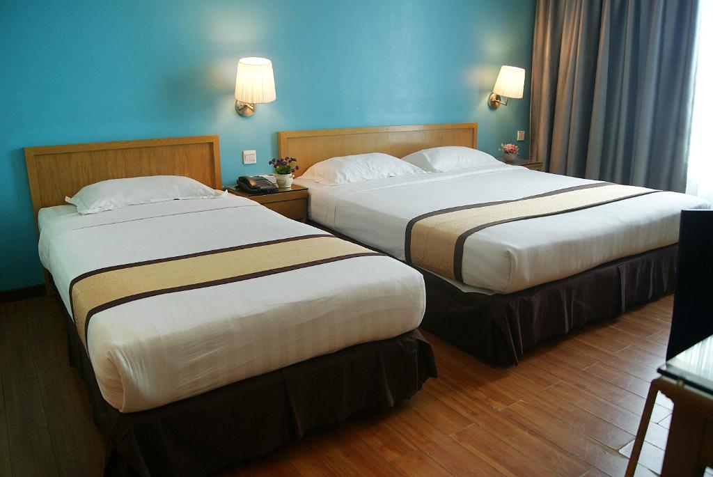 Postel nebo postele na pokoji v ubytování Tang Dynasty Bay Hotel