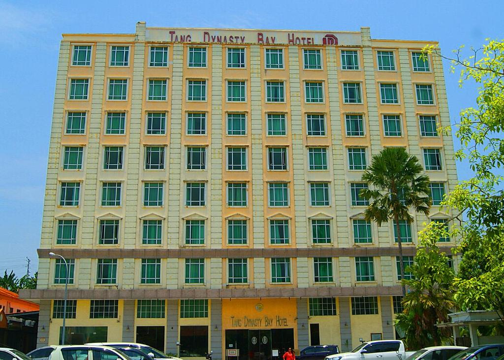 a large yellow building with a sign on it at Tang Dynasty Bay Hotel in Kota Kinabalu