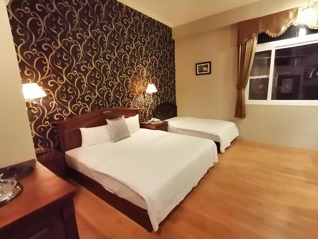 Postel nebo postele na pokoji v ubytování Di Bao Motel