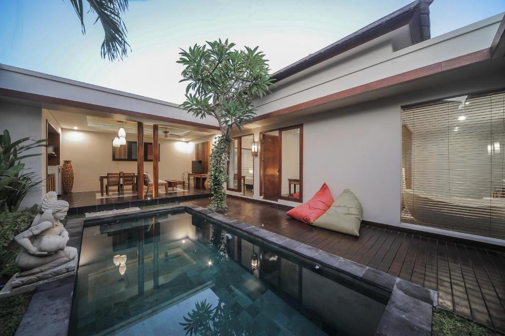 a swimming pool in the backyard of a house at Gaing Mas Jimbaran Villas by Gaing Mas Group in Jimbaran