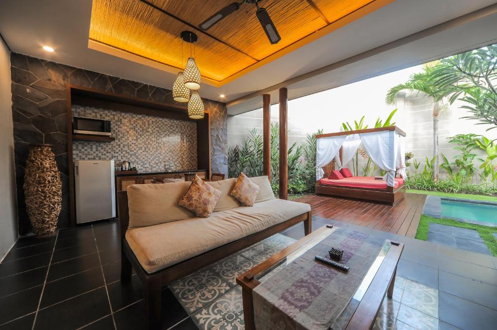 a living room with a couch and a table at Gaing Mas Jimbaran Villas by Gaing Mas Group in Jimbaran