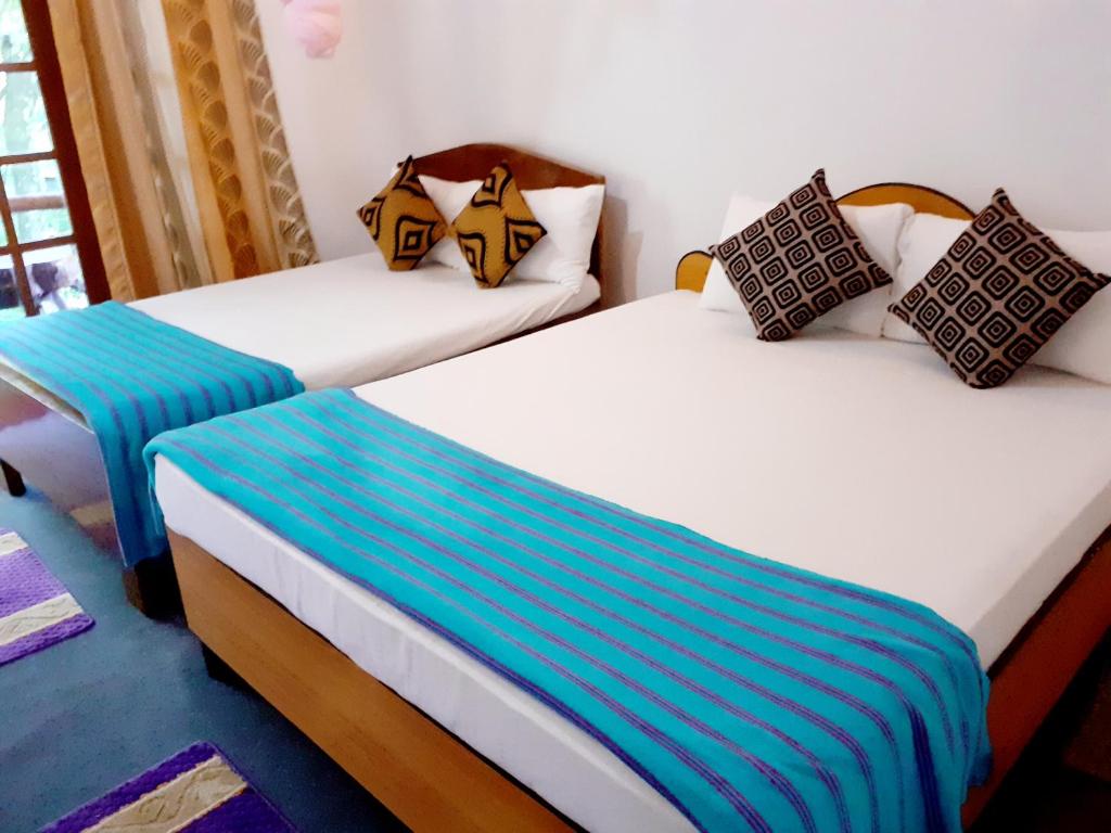 Postel nebo postele na pokoji v ubytování Chamathka homestay
