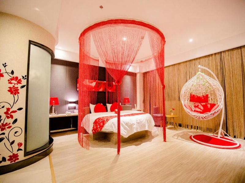 a bedroom with a bed with a red canopy at Thank Inn Plus Hotel Guangxi Baise Tianyang County in Baise