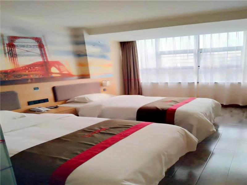 a hotel room with two beds and a window at Thank Inn Plus Hotel Hebei Shijiazhuang Wuji County Bus Station in Shijiazhuang