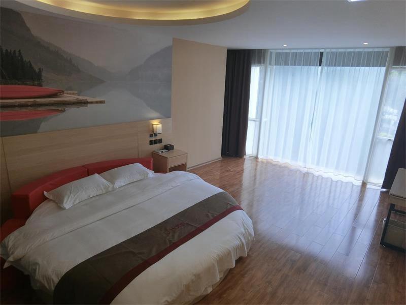 1 dormitorio con cama grande y ventana grande en Thank Inn Plus Hotel Guangxi Liuzhou Donghuan Road Hualinjundi, en Liuzhou