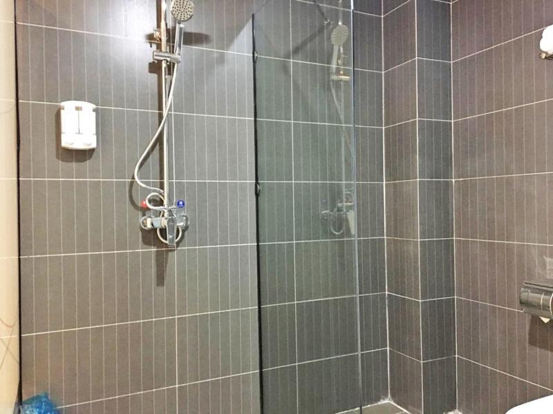 a bathroom with a shower with a glass door at Thank Inn Plus Hotel Henan Anyang Longan District Zhongzhou Road in Anyang