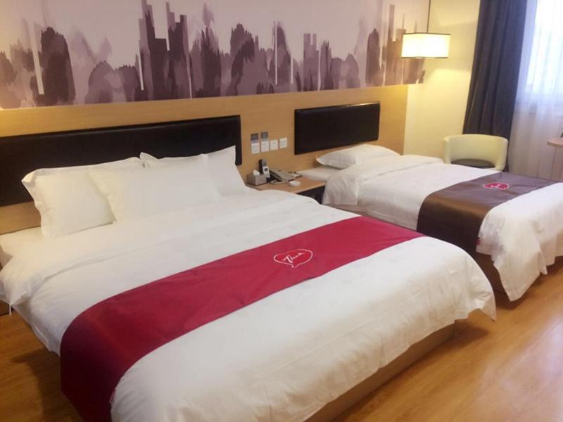 a hotel room with two beds in a room at Thank Inn Plus Hotel Gansu Pingliang Kongtong District Fengshou Road in Pingliang