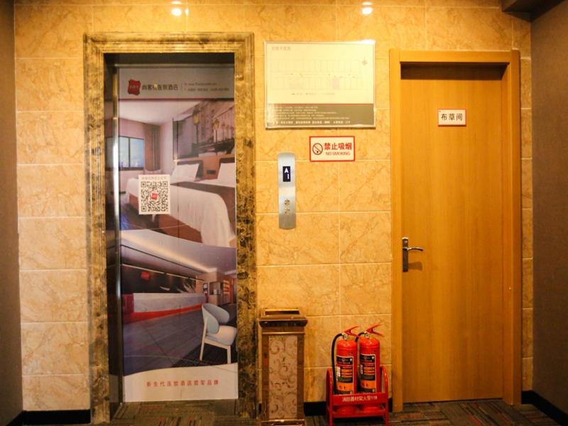 una puerta a una habitación con un cartel en la pared en Thank Inn Plus Hotel Hebei Cangzhou Botou Development Zone Sanjing Road, en Cangzhou