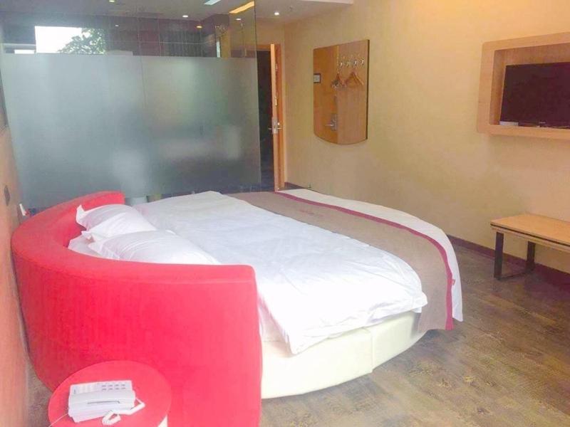 a bedroom with a large bed with a red frame at Thank Inn Plus Hotel Hebei Handan Hanshan District Fu Southeast Street in Handan