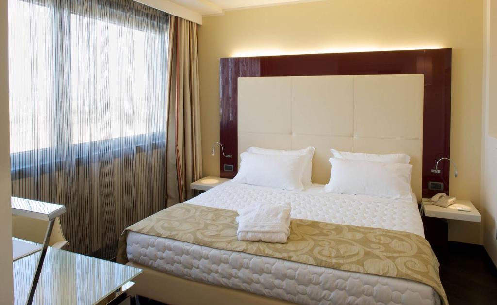 Posteľ alebo postele v izbe v ubytovaní Grand Hotel Mattei