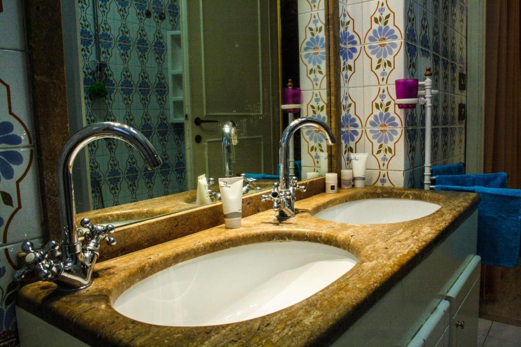 a bathroom with two sinks and a mirror at 4 Season B&B Roma in Rome