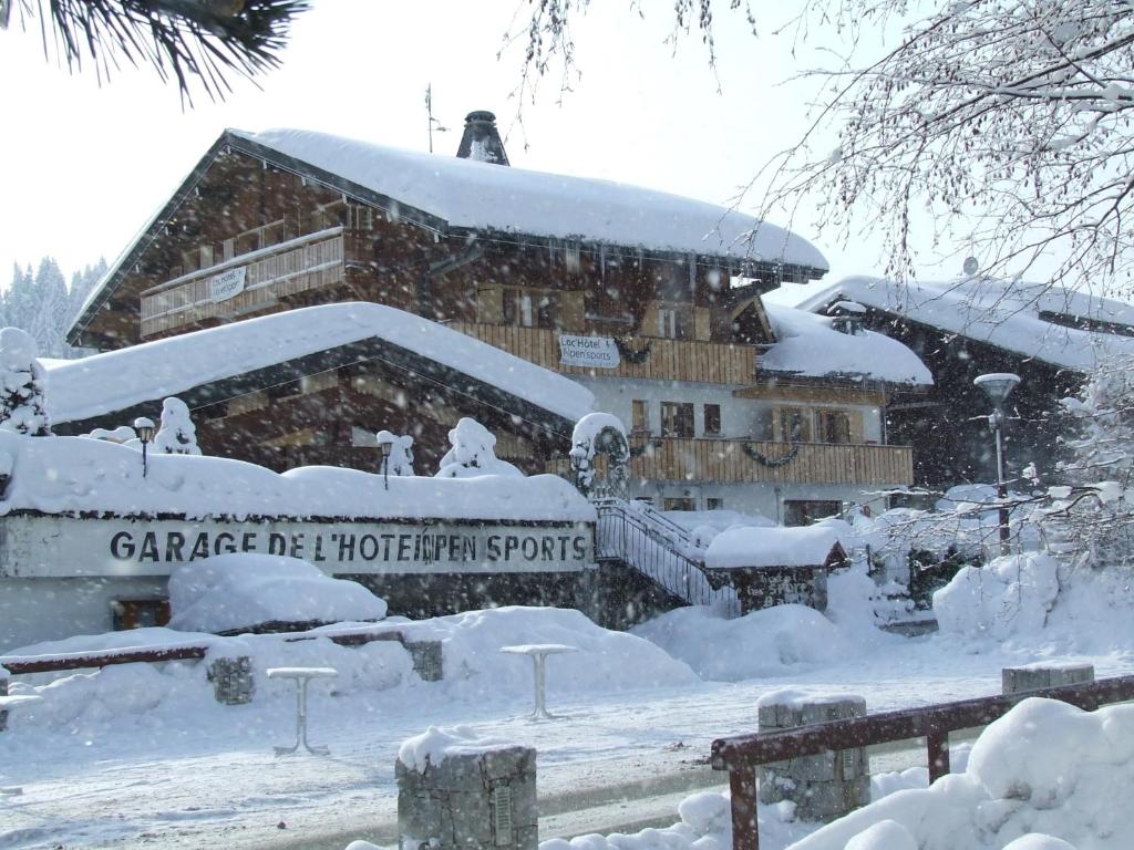 a house that has some snow on the ground at Loc'Hotel Alpen Sports in Les Gets