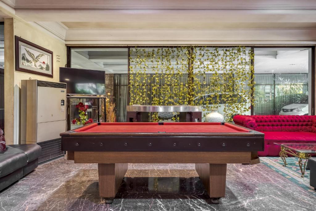 a living room with a pool table in it at New Grand Park Hotel in Surabaya