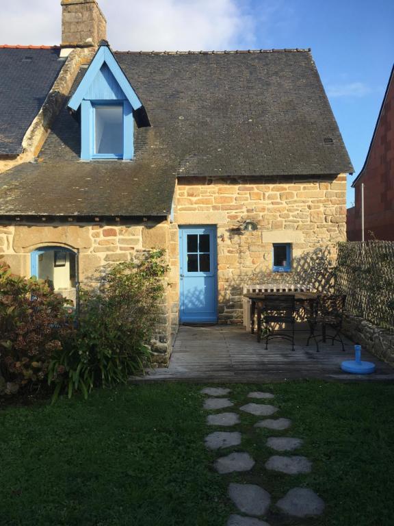 a stone house with a blue door and a picnic table at La Maison Bleue in Baden