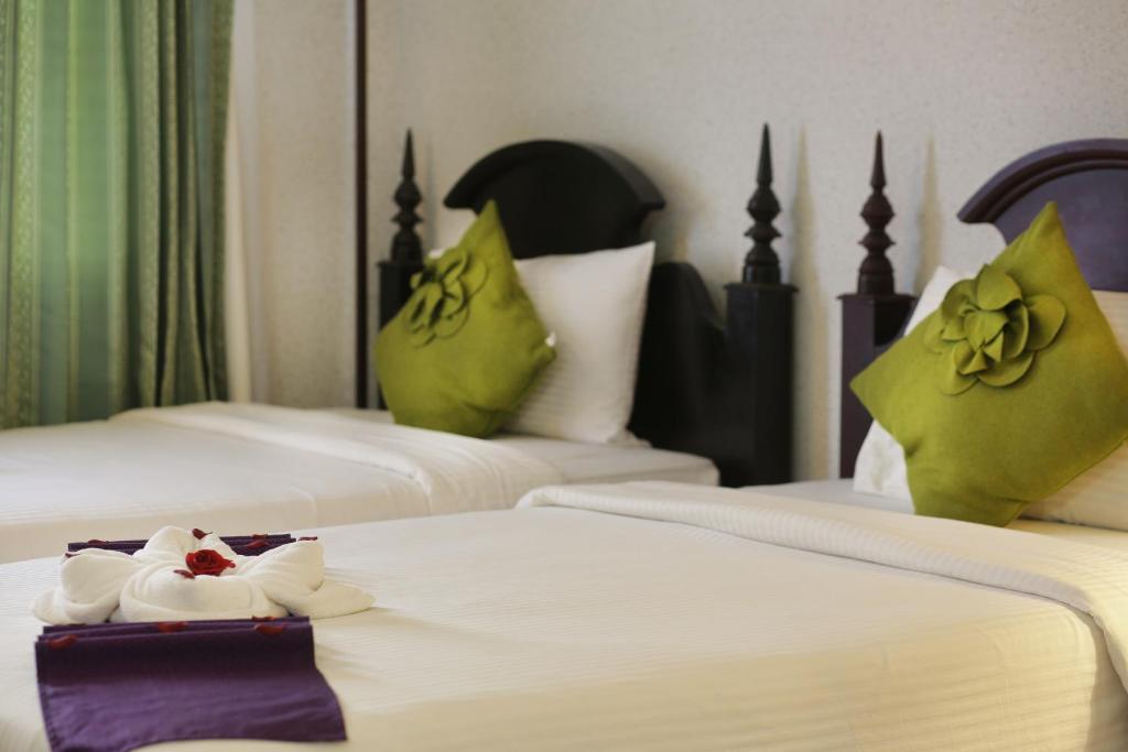 Postel nebo postele na pokoji v ubytování Lucky Angkor Hotel & Spa