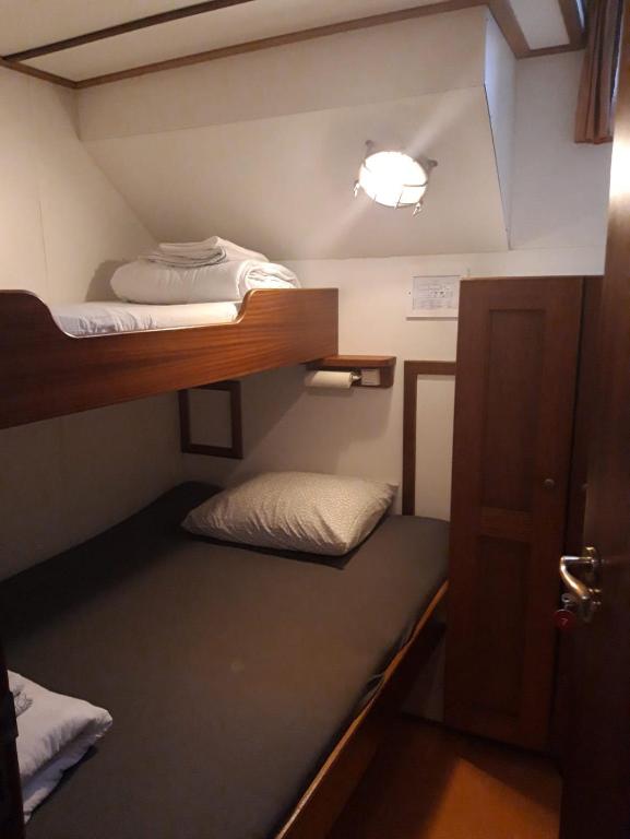 a small room with two bunk beds in it at Felicitas in Amsterdam