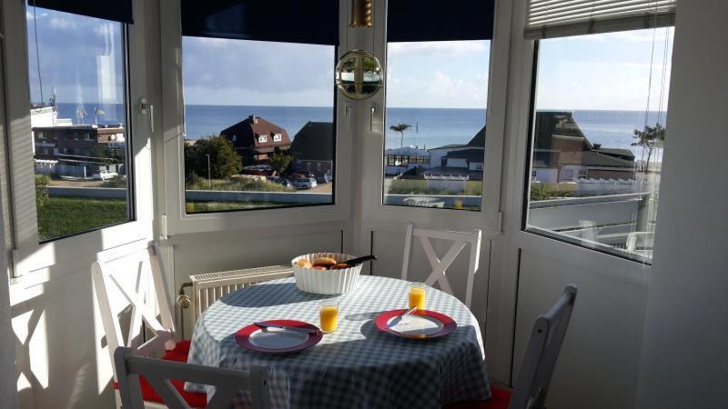 a table in a room with a view of the ocean at Seeschloss 30 in Dahme