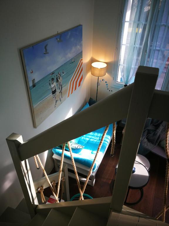 a living room with a picture of a surfboard on the wall at Study du pêcheur in Trouville-sur-Mer