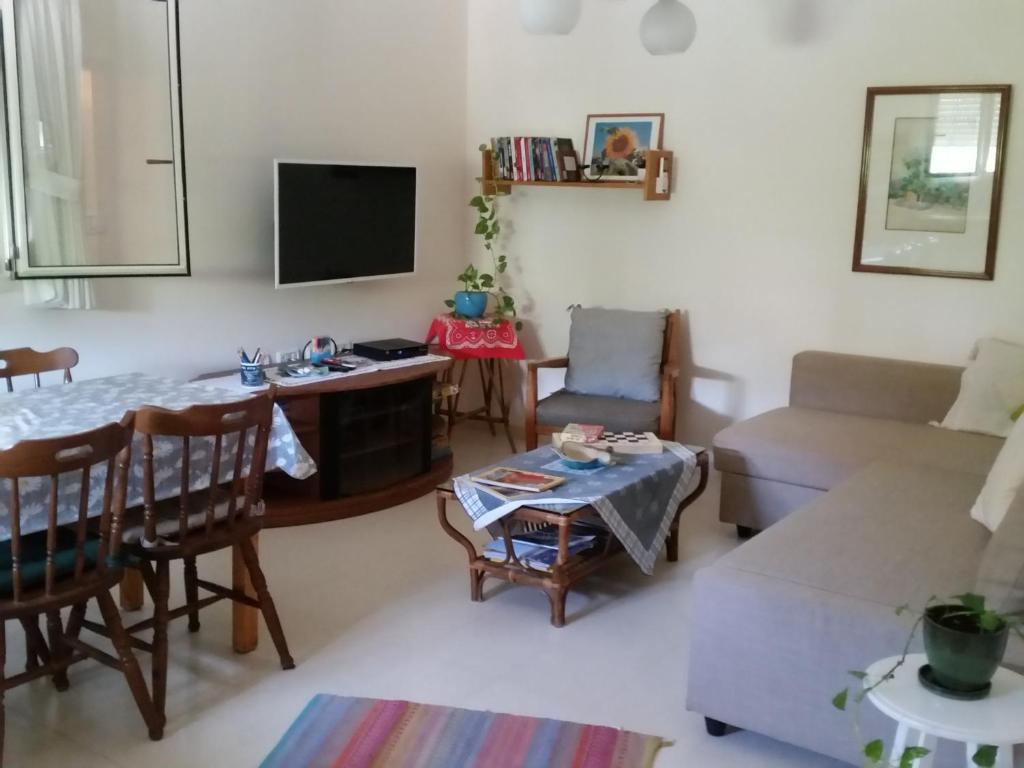 a living room with a couch and a table at Beit Haner Moshav Dor in Dor