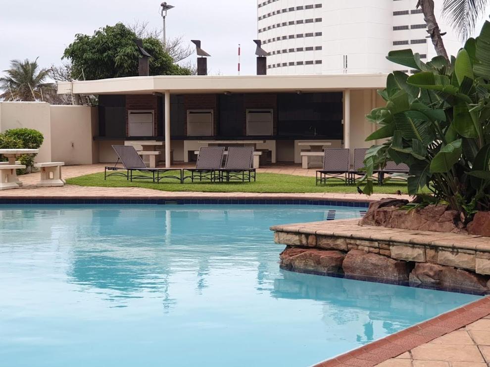 a swimming pool in front of a building at 105 Sea Lodge in Durban