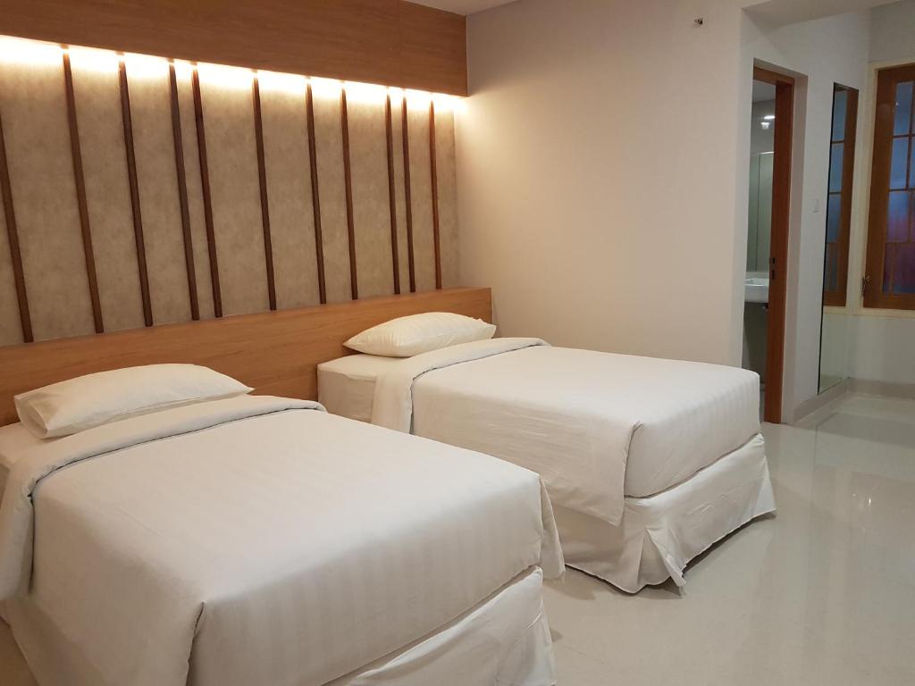Una cama o camas en una habitación de Choice City Hotel