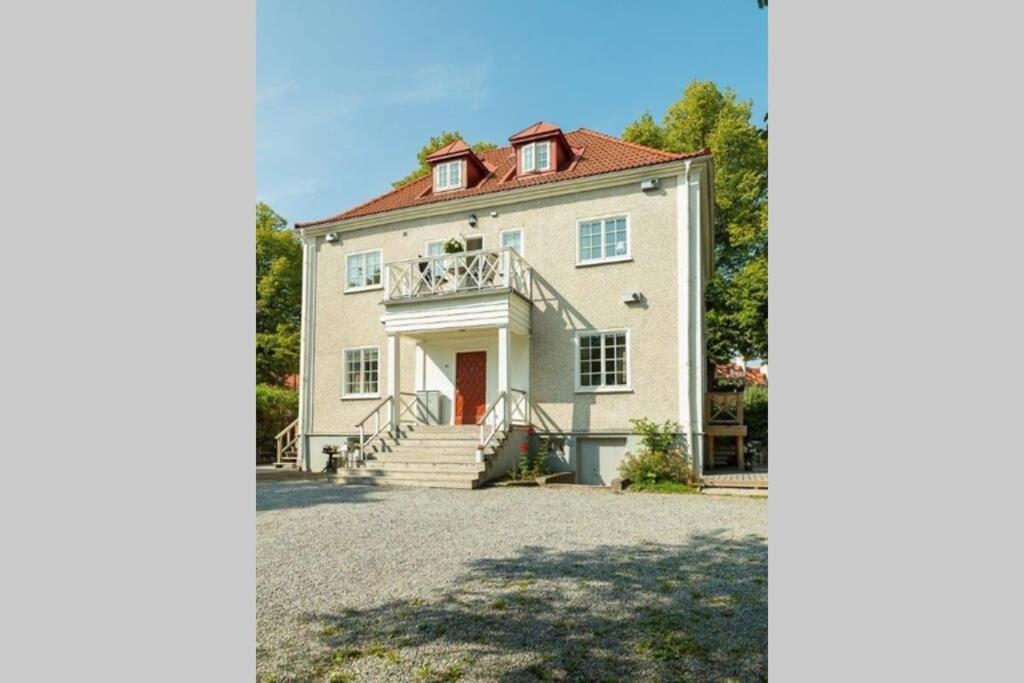 a large white house with a red roof at Central beautiful modern accommodation near Stockholm City in Stockholm