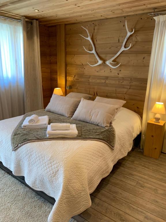 a bedroom with a bed with two towels on it at Chez Fred et Carine (Petit-déjeuner bio inclus) in Auron
